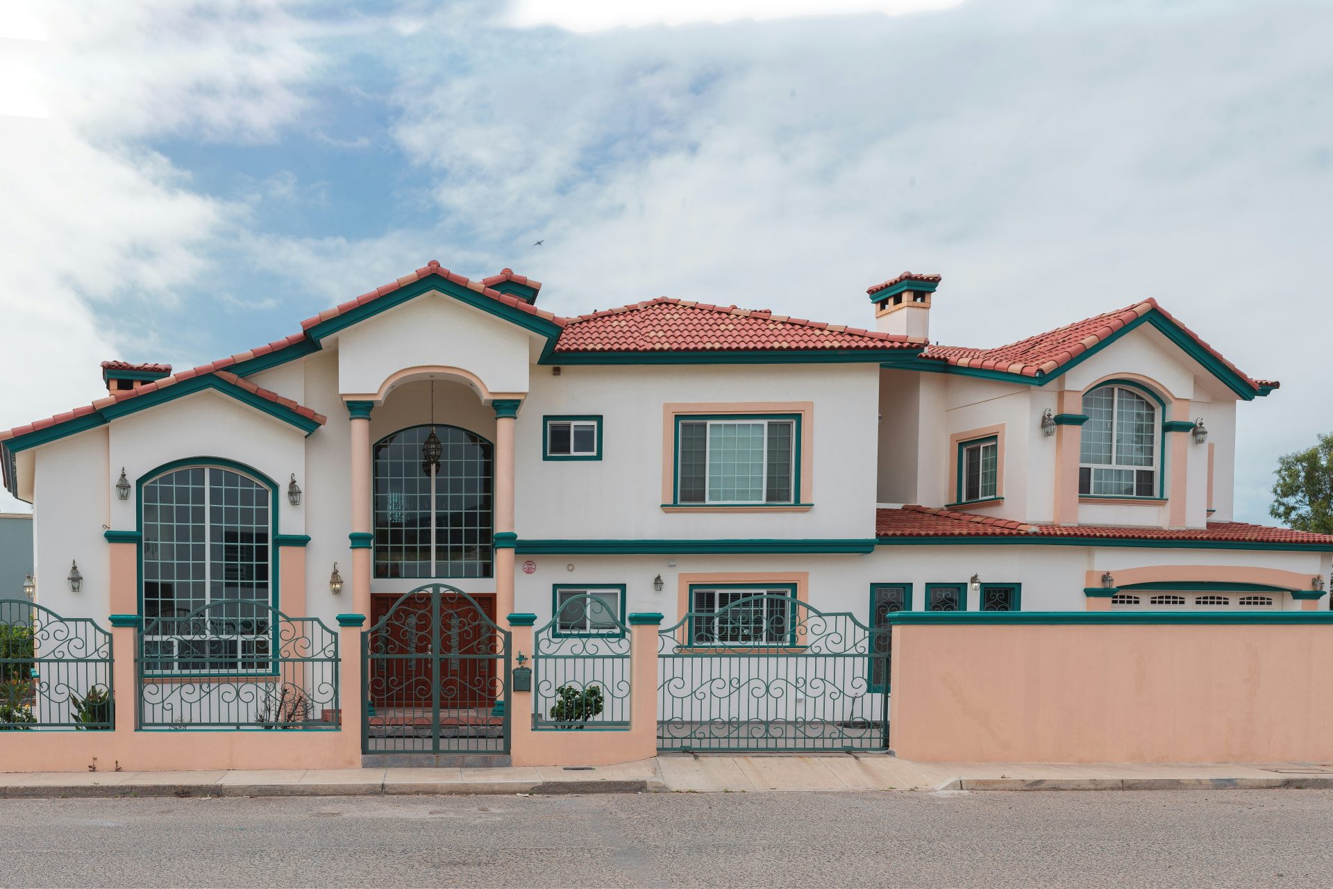 a pink and white house with a red roof